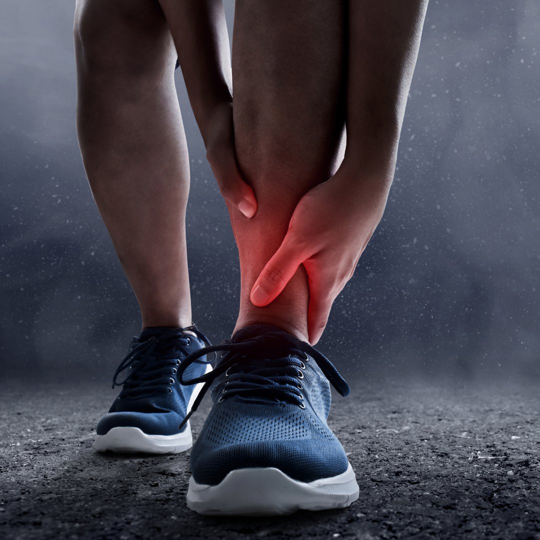 Person holding an ankle in pain after a sports injury