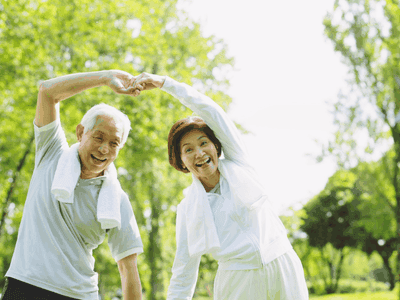 Happy senior couple stretching outdoors