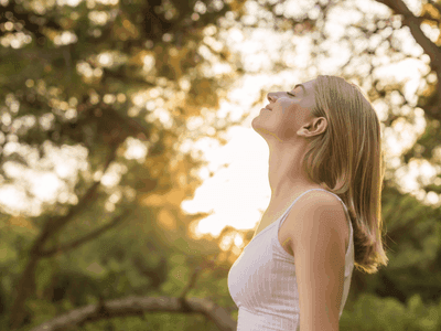 Woman breathing fresh air outdoors